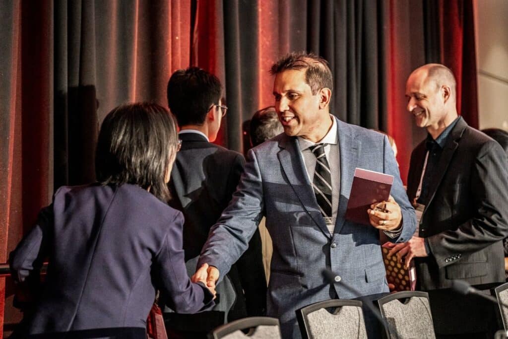 People shaking hands at event