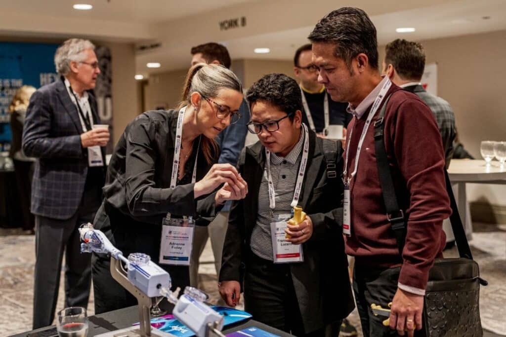 People discussing at a conference booth.