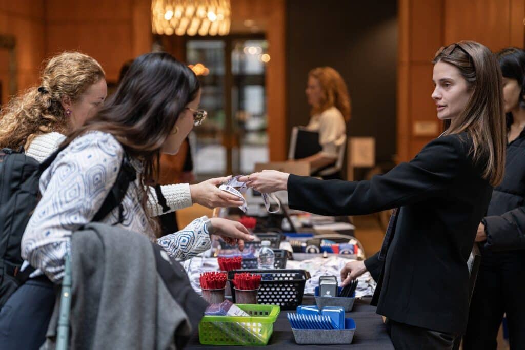 People exchanging items at a table.